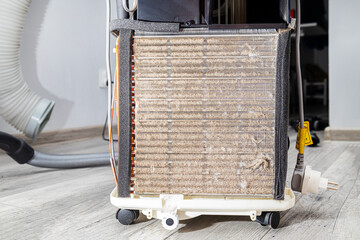 Dirty refrigerator radiator, cooler clogged with dust and dirt