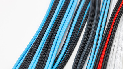Close-up of cables in a system unit, blue computer wiring in a braided sheath
