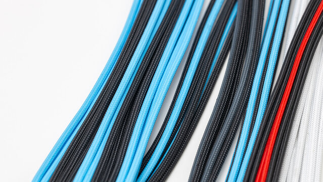 Close-up of cables in a system unit, blue computer wiring in a braided sheath