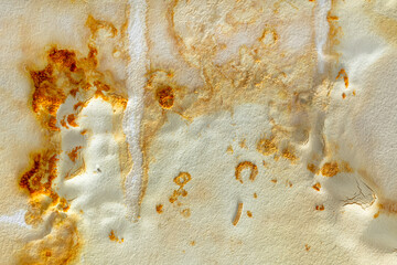 Yellow stains of mold and fungal bacteria on a white wall after a flood
