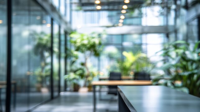 Abstract blurry office interior with modern design, glass walls, natural light, and greenery