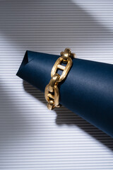 18kt yellow gold chain bracelet set on colored sheets of paper