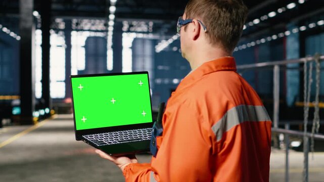 Green screen laptop with industrial staff in a workshop manages fabrication tools, showing engineering concepts, workforce responsibility and the heavy operation requirements. Camera B.