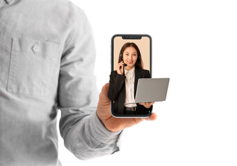 Female Asian technical support agent in headset with laptop on beige background