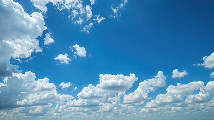 Bright blue sky with scattered white clouds on a clear day.