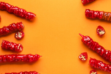 Frame made of tasty churchkhela on orange background