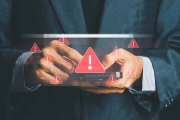 System warning alert on a virtual interface with hand interaction, showing cybersecurity risks, data breaches, malware threats, hacking attempts, and digital system vulnerability in modern technology.