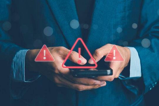 System warning alert on a virtual interface with hand interaction, showing cybersecurity risks, data breaches, malware threats, hacking attempts, and digital system vulnerability in modern technology.