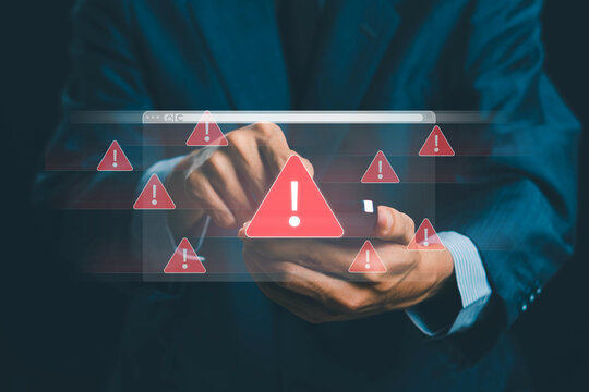 System warning alert on a virtual interface with hand interaction, showing cybersecurity risks, data breaches, malware threats, hacking attempts, and digital system vulnerability in modern technology. - Powered by Adobe