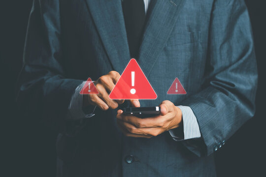 System warning alert on a virtual interface with hand interaction, showing cybersecurity risks, data breaches, malware threats, hacking attempts, and digital system vulnerability in modern technology.