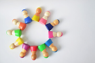 Diverse colorful wooden figures forming a community circle