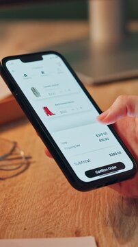 Hands, scroll and online shopping with phone screen for fashion sale, purchase and add to cart in home. Shopper, woman and browsing with tech for ecommerce website, shoes order or payment approved.