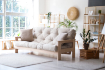 Fototapeta premium Interior of stylish living room with grey sofa, blurred view