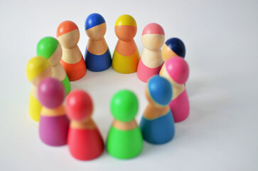 Diverse colorful wooden figures forming a circle