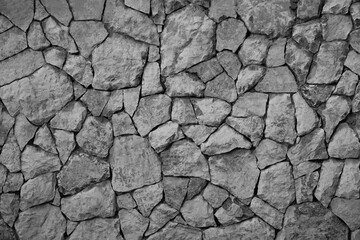 Seamless realistic texture of old big stone Wild stone wall serving as a decorative background Close-up of stone fence  Empty wild stone cladding wall background, rustic interior design.