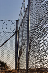 Razor Wire Fence Symbolizing Criminal Justice, Prison, Incarceration, Detention and Security  and border control