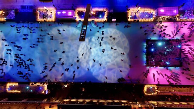 Aerial view of ice skating rink in Montreal with colorful lights and winter motion. g.