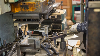 Metal Press Machine Operation with Worker Handling Sheet Metal in Factory