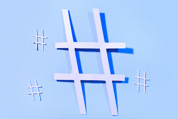 Obraz premium Hashtags made of paper on blue background