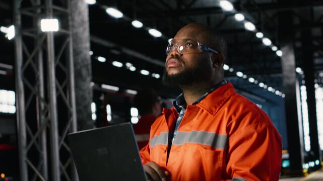 Factory personnel inspecting steel machinery in a warehouse plant, highlighting the professional job role, engineering precision and the large scale power of industrial production. Camera B.