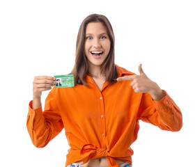 Happy young woman pointing at driving license isolated on white background