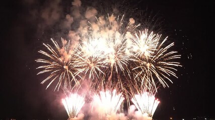 Spectacular golden fireworks exploding in night sky creating vibrant celebration atmosphere perfect for holiday events and festive gatherings
