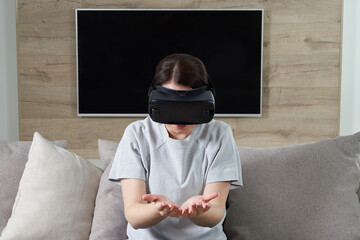 Happy young woman playing on VR glasses indoor, Virtual reality concept with young girl having fun with headset goggles, with copy space
