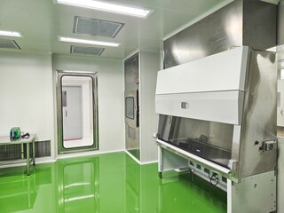 Cleanroom with green floor and stainless steel equipment.
