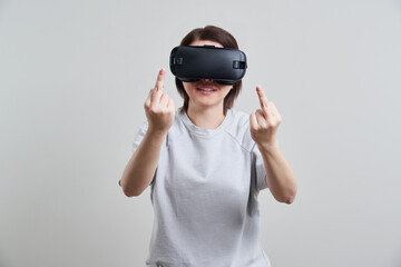 Happy young woman playing on VR glasses indoor, Virtual reality concept with young girl having fun with headset goggles, with copy space
