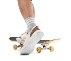 Legs of young man with skateboard on white background © Pixel-Shot