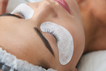 lash laminating and painting, closeup face. Beauty procedures in cosmetology clinic
