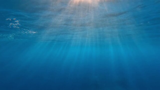 Abstract underwater scene with sunrays and air bubbles. 