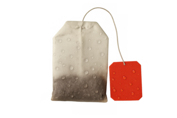 Tea bag with red tag and water drops, dipping and brewing a refreshing herbal drink on transparent background