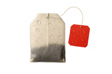 Tea bag showing moisture, water drops covering the paper and red label, concept of refreshing a drink. Transparent background