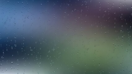 Raindrops on glass window creating a blurred abstract background with colorful hues evoking a