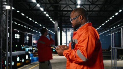 Black male technician in a warehouse inspecting metal automation tools, representing assembly tasks for professional engineering. Production workflow essential to industrial manufacturing. Camera A. - Powered by Adobe