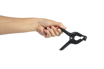 A studio shot of a black plastic spring clamp in hand isolated on a transparent background