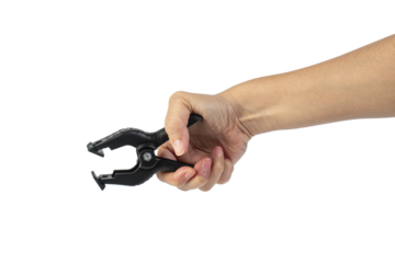 A studio shot of a black plastic spring clamp in hand isolated on a transparent background