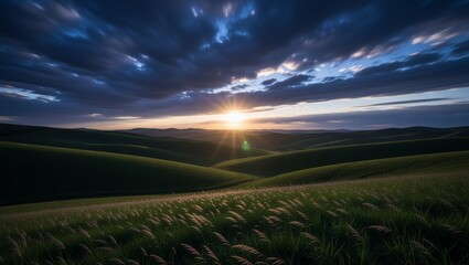 Sunset over rolling hills with meadow and winding road