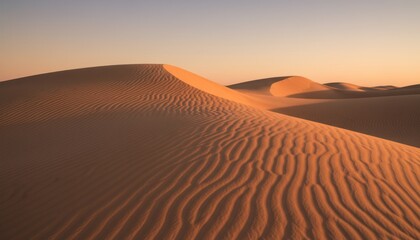 Tranquil golden desert landscape with rippled sand dunes at sunset creating serene atmosphere