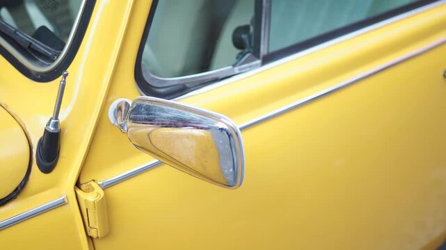 Classic yellow car parked by the roadside