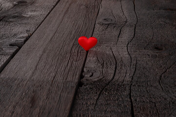 Red Heart on Rustic Wooden Plank Evoking Love and Warmth