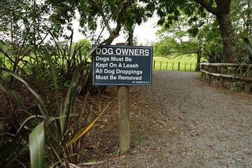 Sign Indicating Dog Owner Responsibilities In Park Area