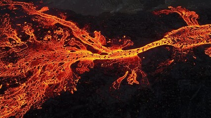Volcanic eruption, red burning lava erupts from ground, drone fly over active volcano crater in Iceland - Powered by Adobe