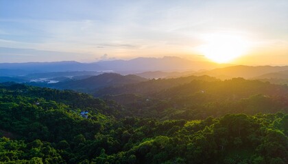 Mountains and green rainforest at sunset suitable for travel brochures, environmental websites, tropical vacation advertisements, and naturethemed designs.
