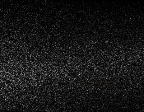 Dark, grainy texture background showing variations in light and shadow in an abstract way