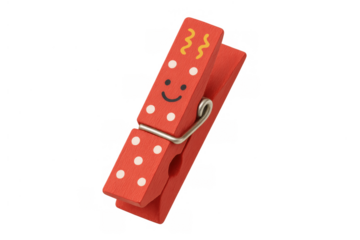 Red wooden clothespin decorated with white polka dots and a happy smiley face. Craft item for organization, transparent background