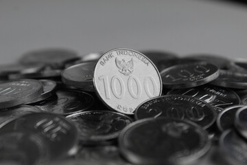 Close-up of Piles of Indonesian Rupiah Coins ($IDR$) for Finance, Business, and Economy.