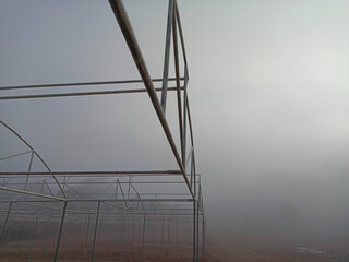 Misty view through a window or structure with fog obscuring the landscape