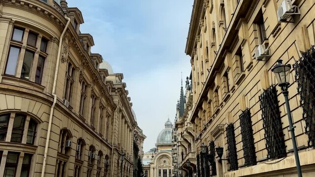 classic european architecture lining a narrow bucharest street toward cec palace